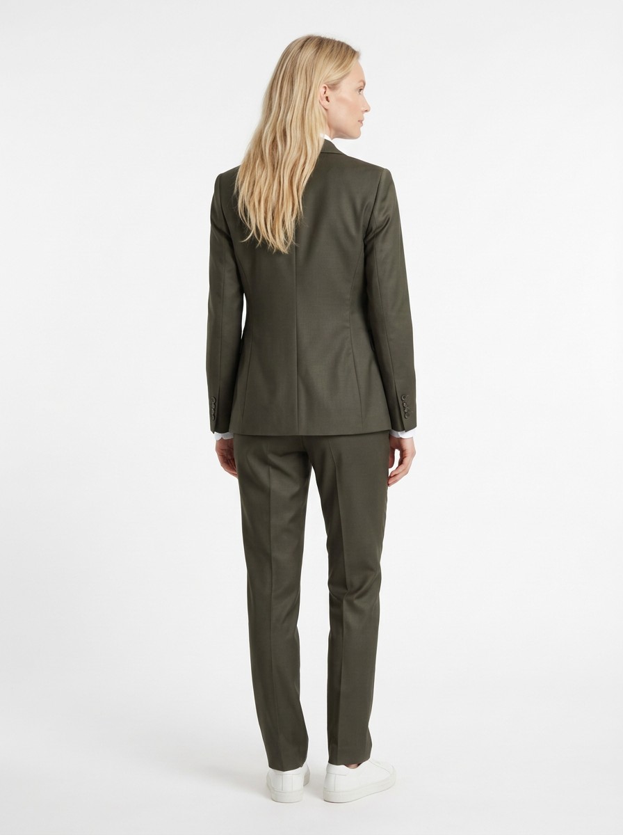 AI-generated woman wearing olive tailoring, back view